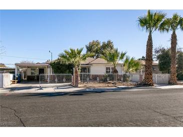 Ranch-style home with palm trees and a fenced yard at 1229 S 9Th St, Las Vegas, NV 89104