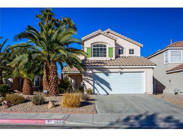 Two-story house with attached garage, landscaping, and palm trees at 1608 Council Bluff Ln, North Las Vegas, NV 89031