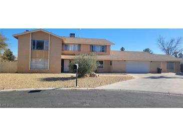 Two-story house with attached two-car garage and landscaped yard at 1695 Westwind Rd, Las Vegas, NV 89146