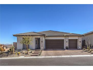 Single-story home with two-car garage and landscaped front yard at 210 Bella Noche St, Las Vegas, NV 89138