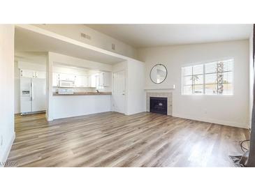 Bright living room with fireplace and laminate flooring at 2725 S Nellis Blvd # 2197, Las Vegas, NV 89121