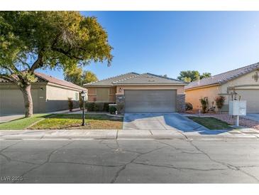 Single-story home with attached garage and landscaped yard at 3514 Old Course St, Las Vegas, NV 89122