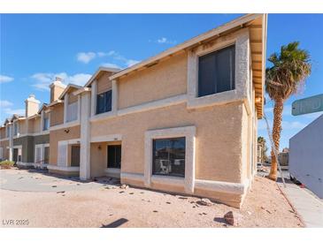 Two-story building exterior, featuring light-colored siding and landscaping at 3802 Terrazzo Ave, Las Vegas, NV 89115