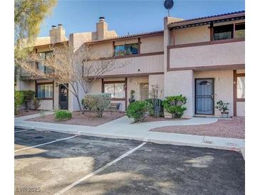 Two-story stucco condo with private entrance and landscaping at 5261 Janfred Ct # 33, Las Vegas, NV 89103