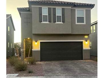 Two-story house with gray exterior, dark garage door, and landscaping at 5773 Holbeche St, Las Vegas, NV 89113