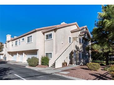 Two-story condo building with attached garages and landscaping at 7450 S Eastern Ave # 2011, Las Vegas, NV 89123