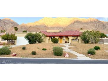 One-story home with red tile roof, desert landscaping, and mountain views at 1032 Morning Sun Way, Las Vegas, NV 89110