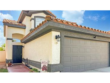 Two-story house with gray garage door and Spanish tile roof at 3350 Stacey Lyn Dr, Las Vegas, NV 89117