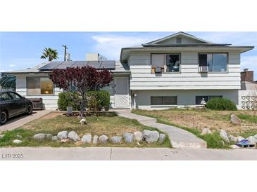 Charming two-story home with solar panels, a small tree, and a simple landscaped front yard at 6324 Fairwood Ave, Las Vegas, NV 89107