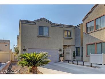 Two-story house with attached garage and landscaped front yard at 6329 Kitamaya St, North Las Vegas, NV 89031