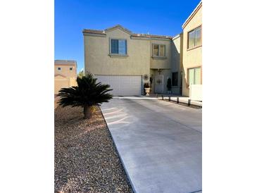 Two-story house with attached garage and desert landscaping at 6329 Kitamaya St, North Las Vegas, NV 89031