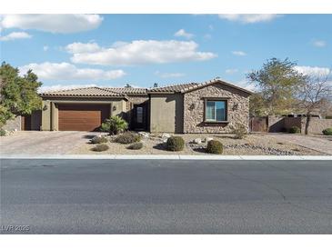 Single-story home with stone accents and a two-car garage at 8716 Purple Wisteria St, Las Vegas, NV 89131