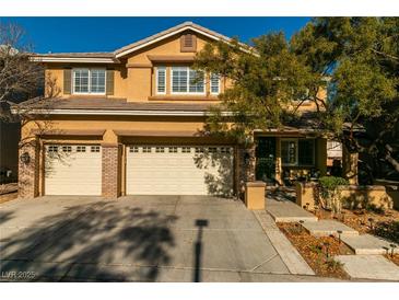 Two-story house with three-car garage, landscaping, and a large tree in the front yard at 10744 Balsam Creek Ave, Las Vegas, NV 89144