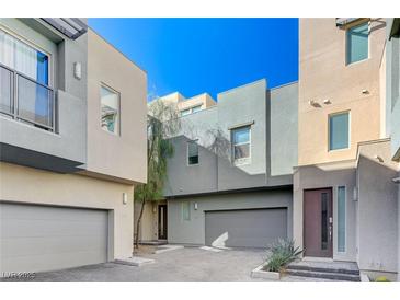 Modern townhome community with attached garages and paved courtyard at 11377 Gravitation Dr # 0, Las Vegas, NV 89135