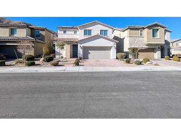 Two-story house with attached garage and landscaping at 12815 Alcores St, Las Vegas, NV 89141