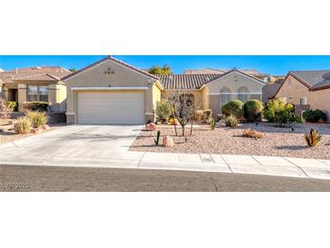 Single-story home with a two-car garage and well-maintained landscaping at 1664 Hartley Ave, Henderson, NV 89052