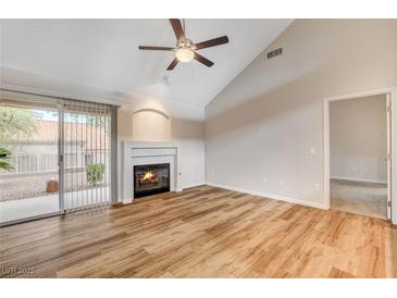 Spacious living room featuring a fireplace and sliding door to patio at 2452 Sunup Dr, Las Vegas, NV 89134