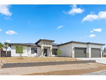 Stunning modern home with a three-car garage and landscaped front yard at 311 Belfast St, Henderson, NV 89015