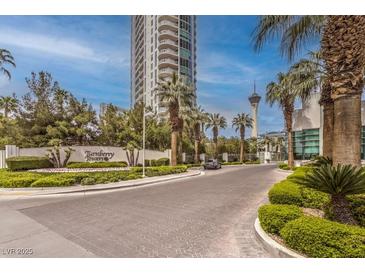 Luxury highrise building with palm trees and paved driveway at 322 Karen Ave # 1001, Las Vegas, NV 89109