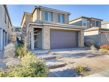 Two-story house with stone accents and a two-car garage at 355 Purple Sandpiper St, Las Vegas, NV 89138