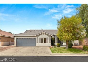 Single-story house with gray siding, attached garage, and landscaped front yard at 3940 Colonial Field Ave, North Las Vegas, NV 89031