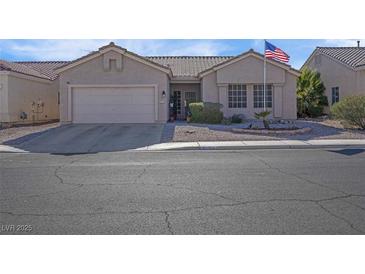 One-story house with attached garage and desert landscaping at 4613 Golden Palomino Ln, North Las Vegas, NV 89032