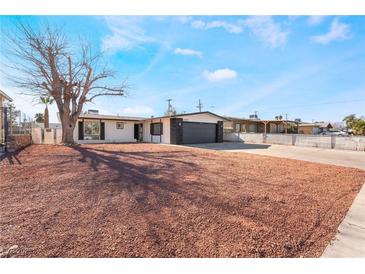 Updated single story home with new landscaping and large driveway at 6005 W Washington Ave, Las Vegas, NV 89107