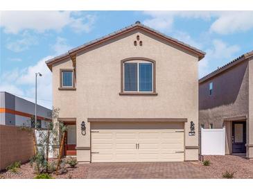 Two-story house with beige siding, a two-car garage, and landscaping at 6240 Blood Lily Ave, Las Vegas, NV 89122