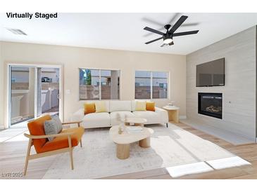 Bright living room with fireplace and access to backyard at 6529 Za Zu Pitts Ave # 102, Las Vegas, NV 89122