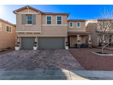 Two-story house with three-car garage and landscaped front yard at 7131 Rosecrans St, Las Vegas, NV 89166