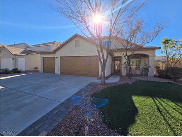 Two-story house with attached garage and landscaped yard at 865 Gleamstar Ave, Las Vegas, NV 89123