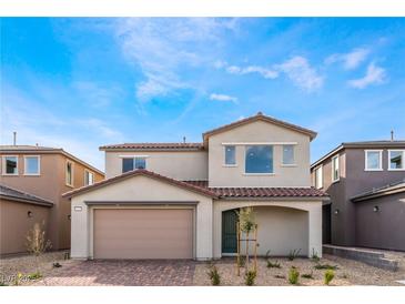 Two-story home featuring a brick driveway, arched entryway, and a neutral color scheme at 9247 Lunar Phase St, Las Vegas, NV 89143