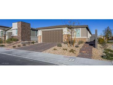 Single-story home with a two-car garage and landscaped front yard at 9428 Noble Fir Ridge Ave, Las Vegas, NV 89143