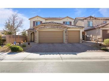 Two-story house with stone accents and a three-car garage at 3957 Little Creek Ave, Las Vegas, NV 89141