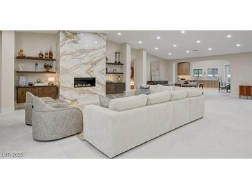 Spacious living room featuring a marble fireplace and modern decor with an open floor plan at 3104 Conners Dr, Las Vegas, NV 89107