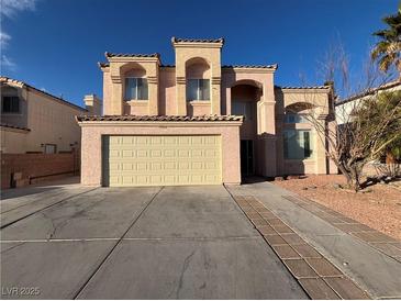 Charming two-story home features a two-car garage, desert landscaping and a Spanish-tile roof at 4466 Palm Grove Dr, Las Vegas, NV 89120