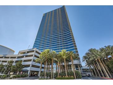 High-rise building with palm trees and parking at 4471 Dean Martin Dr # 1002, Las Vegas, NV 89103