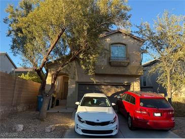 Two-story house with attached garage and landscaping at 6282 Dollar Bill Ct, Las Vegas, NV 89141