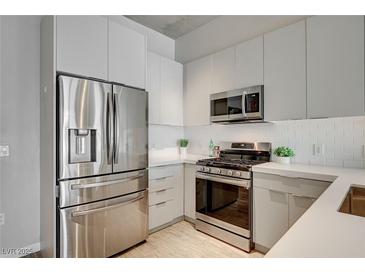 Modern kitchen with stainless steel appliances and white cabinetry at 353 E Bonneville Ave # 457, Las Vegas, NV 89101