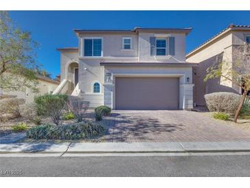 Two-story house with attached garage and landscaped front yard at 10581 Olinda St, Las Vegas, NV 89179