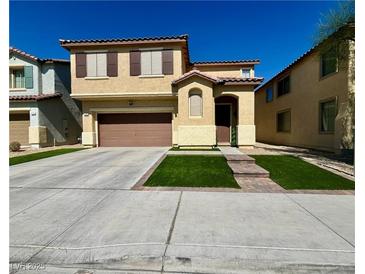 Two-story house with a brown garage door and artificial turf at 1908 W Hammer Ln, North Las Vegas, NV 89031