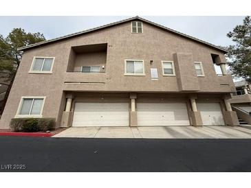 Three-story condo featuring multi-car garage and neutral color palette at 2001 Jasper Bluff St # 102, Las Vegas, NV 89117