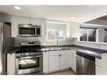 Bright kitchen features stainless steel appliances and white cabinetry at 332 Oakford St, Las Vegas, NV 89110