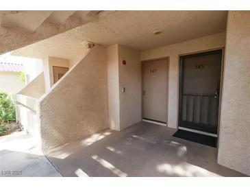 View of the front door with unit numbers 145 and 147 and covered parking area at 3790 Desert Marina Dr # 147, Laughlin, NV 89029