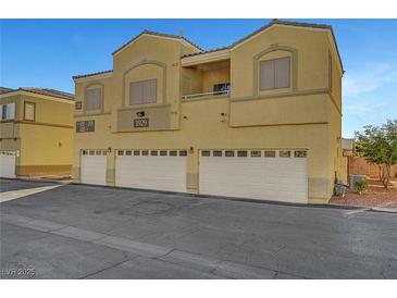 Tan two-story townhome with three-car garage and private entrance at 3929 Pepper Thorn Ave # 101, North Las Vegas, NV 89081