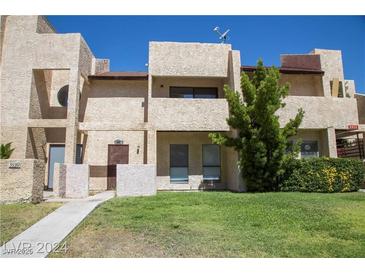 Two-story stucco townhouse with a grassy yard and walkway at 3937 S Torrey Pines Dr, Las Vegas, NV 89103