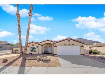 Single-story house with desert landscaping and a two-car garage at 429 Nancy Dr, Henderson, NV 89015