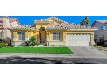 Single-story house with a two-car garage and landscaped lawn at 4532 Laguna Vista St, Las Vegas, NV 89147