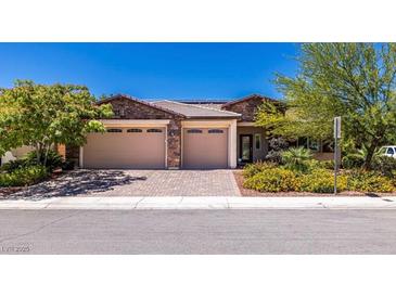 Charming single-Gathering home showcasing a multi-car garage and colorful, mature landscaping at 5170 Agio Ave, Pahrump, NV 89061