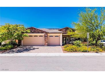 Single-story home with three-car garage and landscaped front yard at 5170 Agio Ave, Pahrump, NV 89061